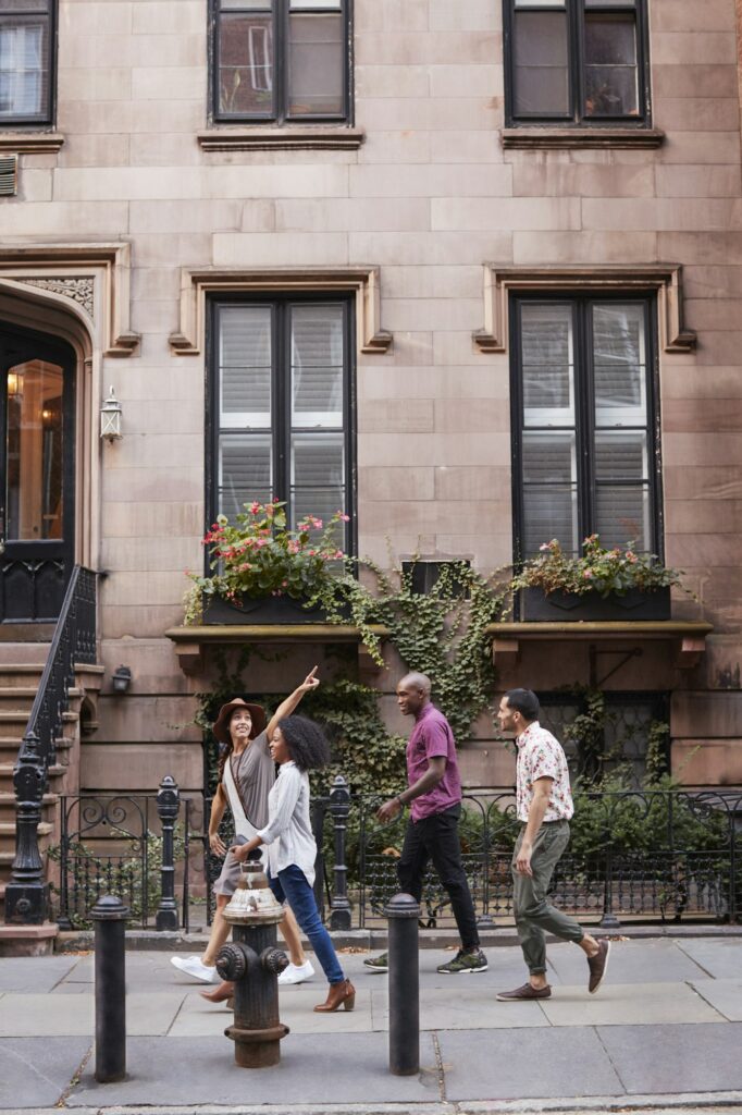 Group Of Friends Walking Along Urban Street In New York City